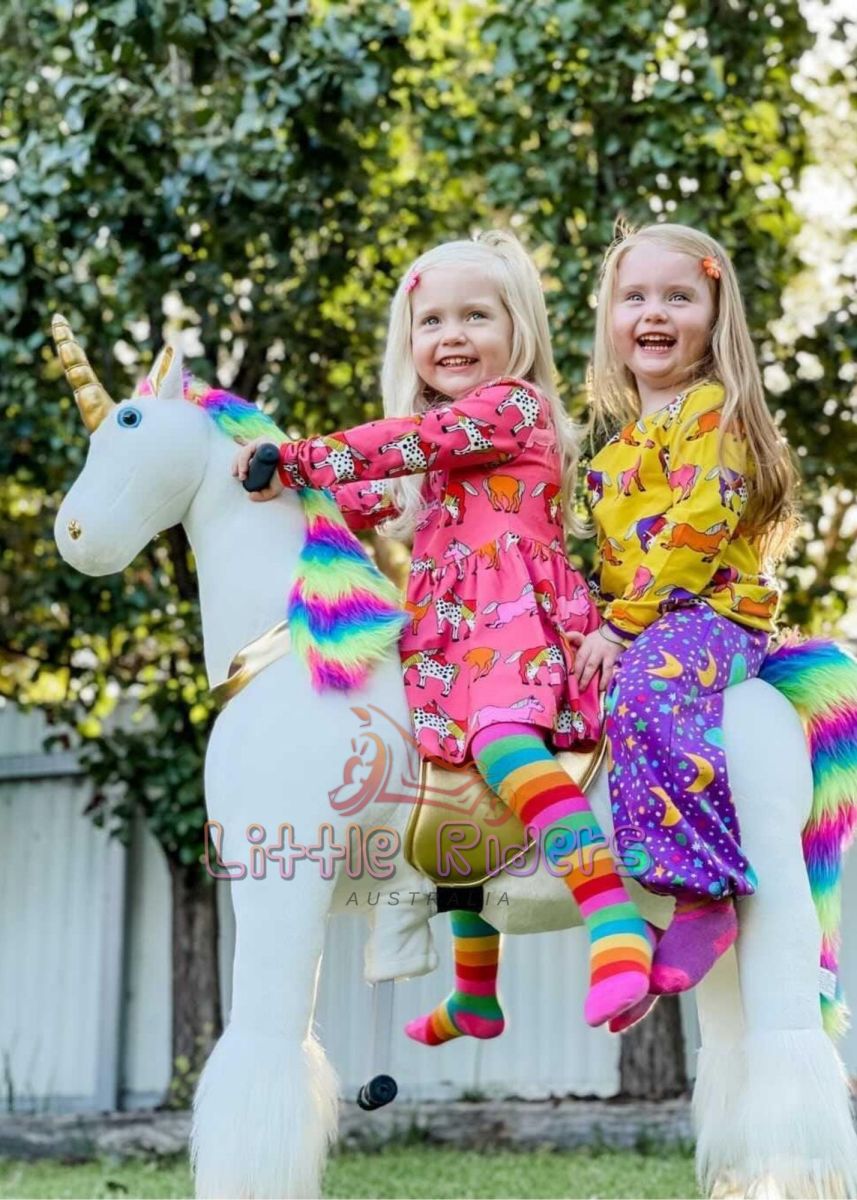 Ride on toys - two pretty girls on rainbow unicorn