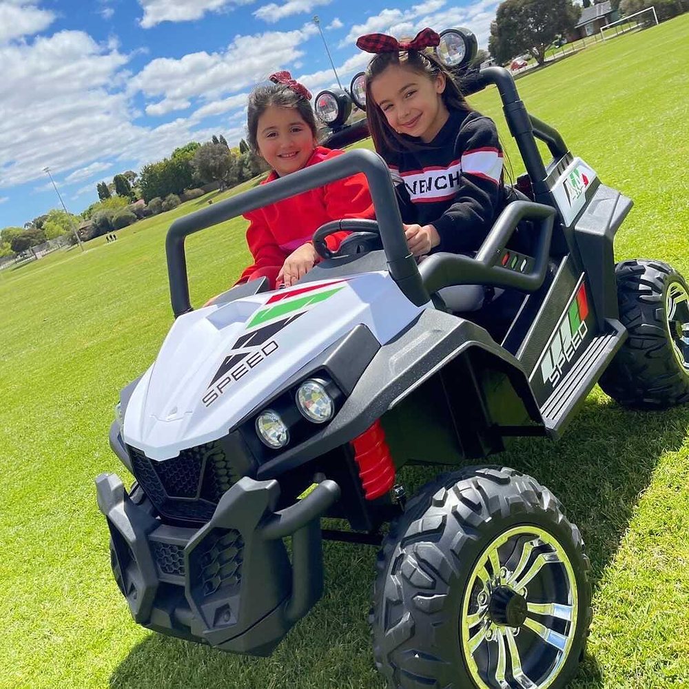 Little Riders 24V 4x4 beach buggy ride-on - two sisters driving their white buggy across the park