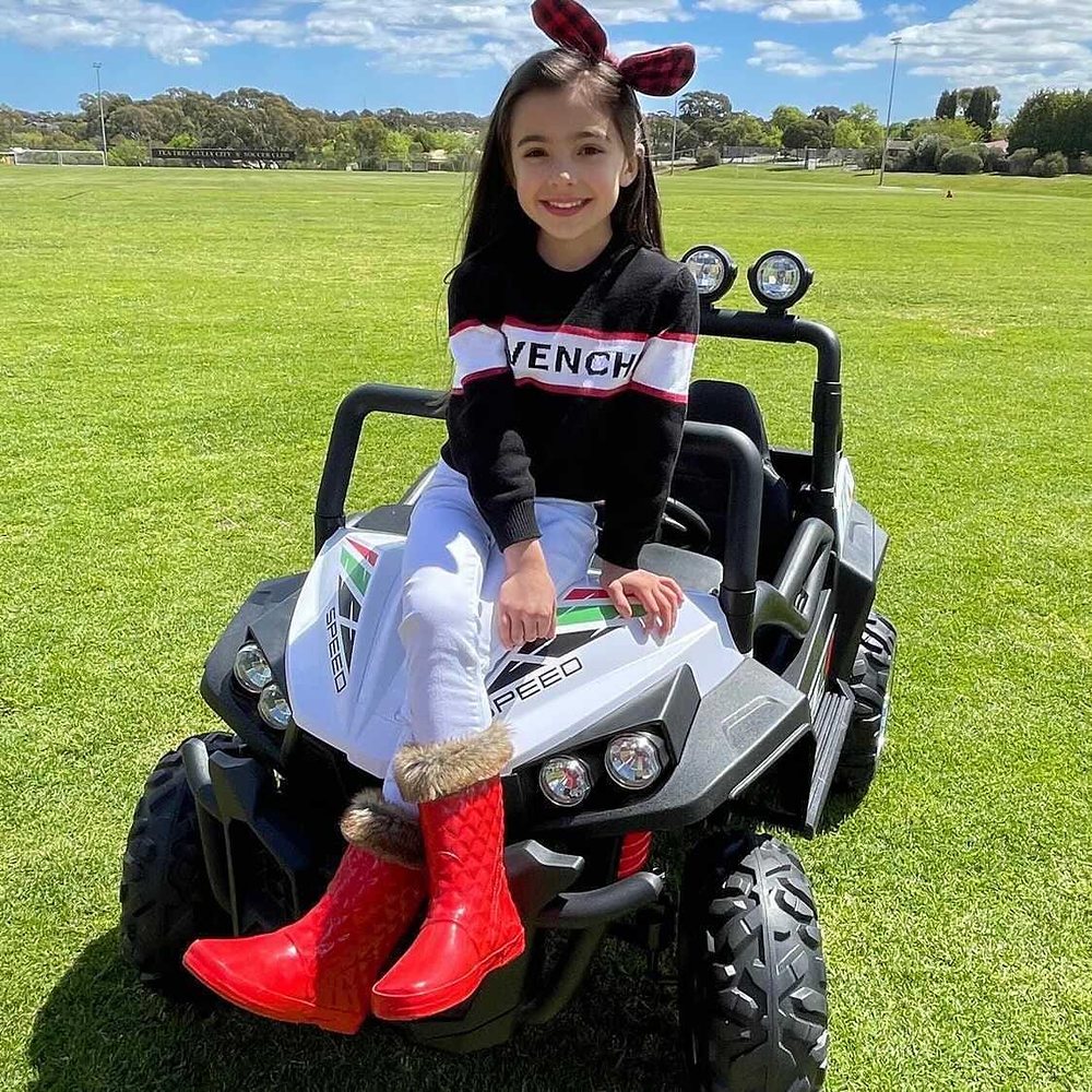 Little Riders 24V 4x4 beach buggy ride-on - girl sitting on the front of her white 4x4 buggy