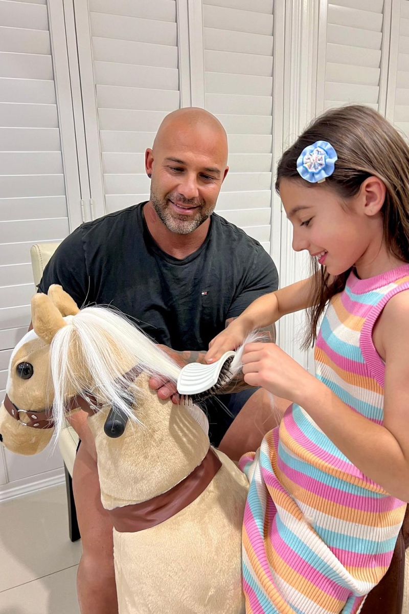 Little Riders light brown ride-on horse toy - girl and dad brushing the horse mane